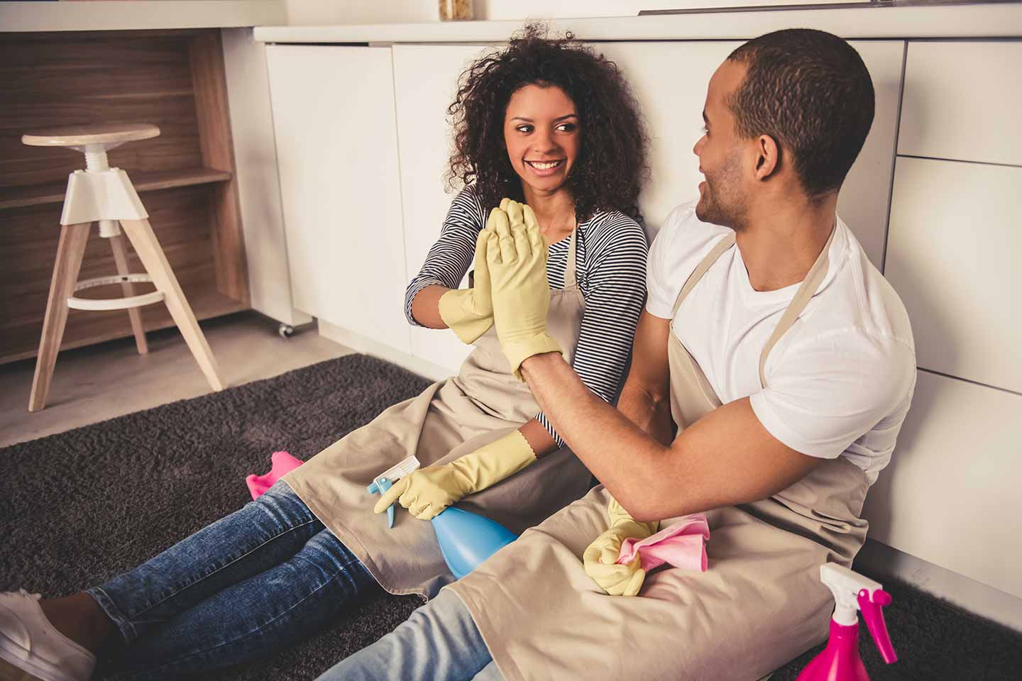 Couple high fiving after a day of cleaning