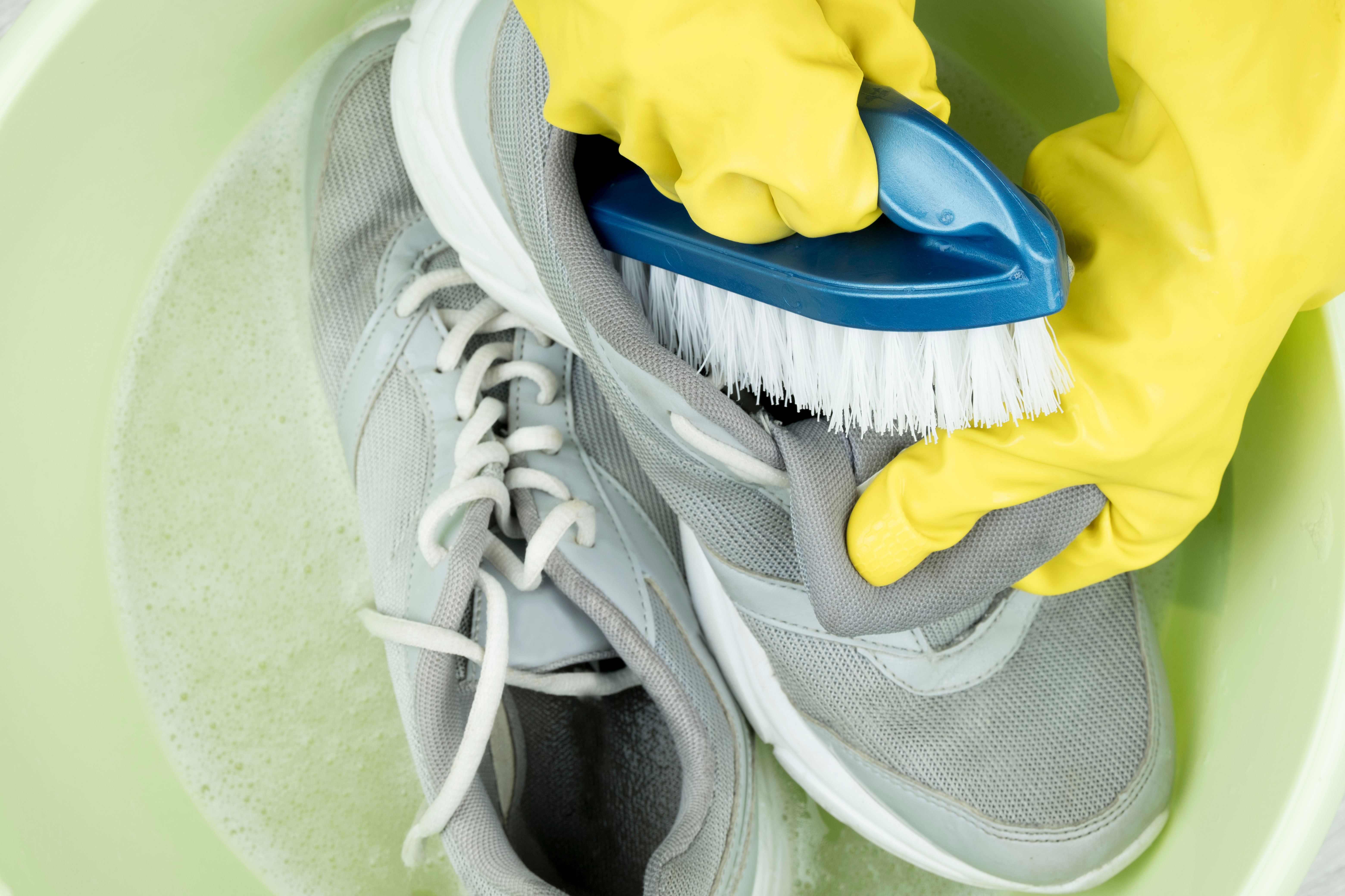 Person scrubbing shoes clean