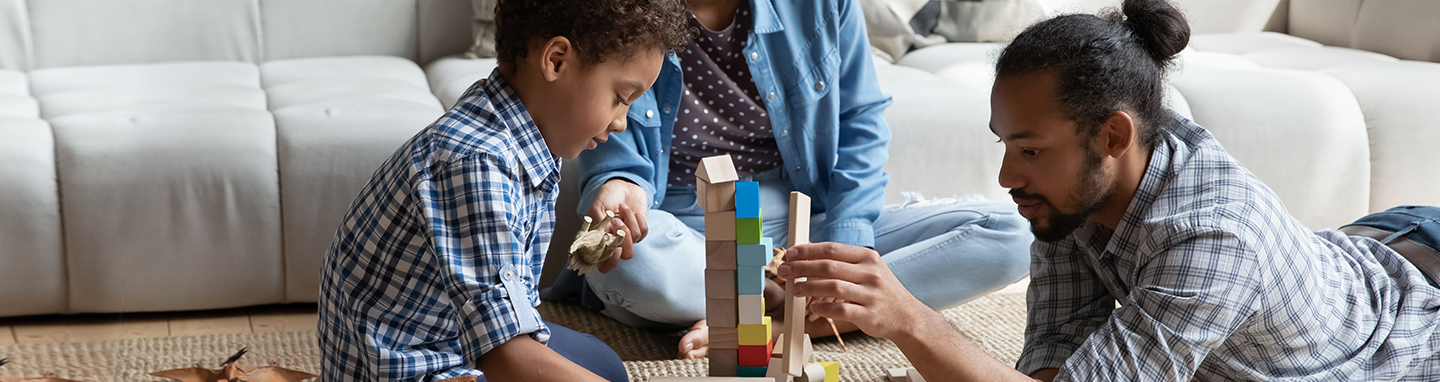 Family playing on a carpet refreshed with OxiClean™ Carpet and Area Rug Stain Remover Spray.