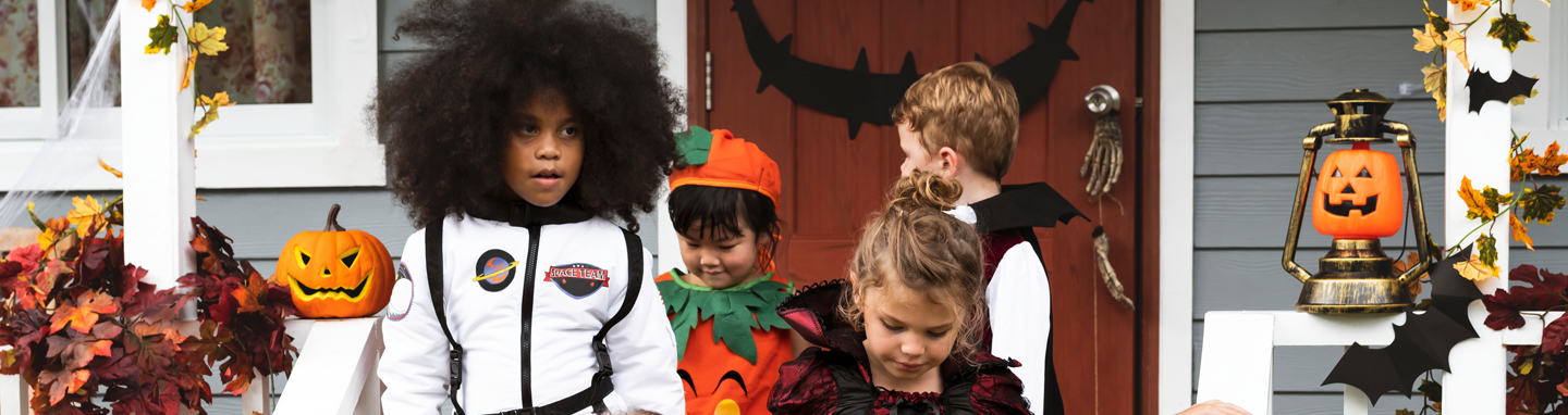 Kids trick or treating in costume on Halloween.