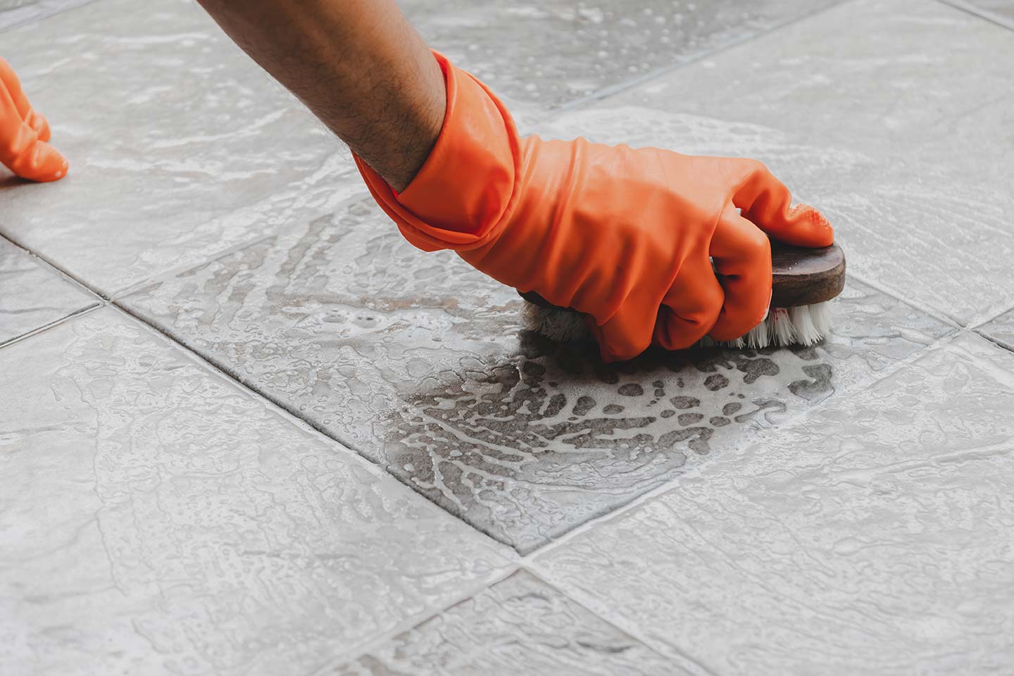 Person scrubbing tile