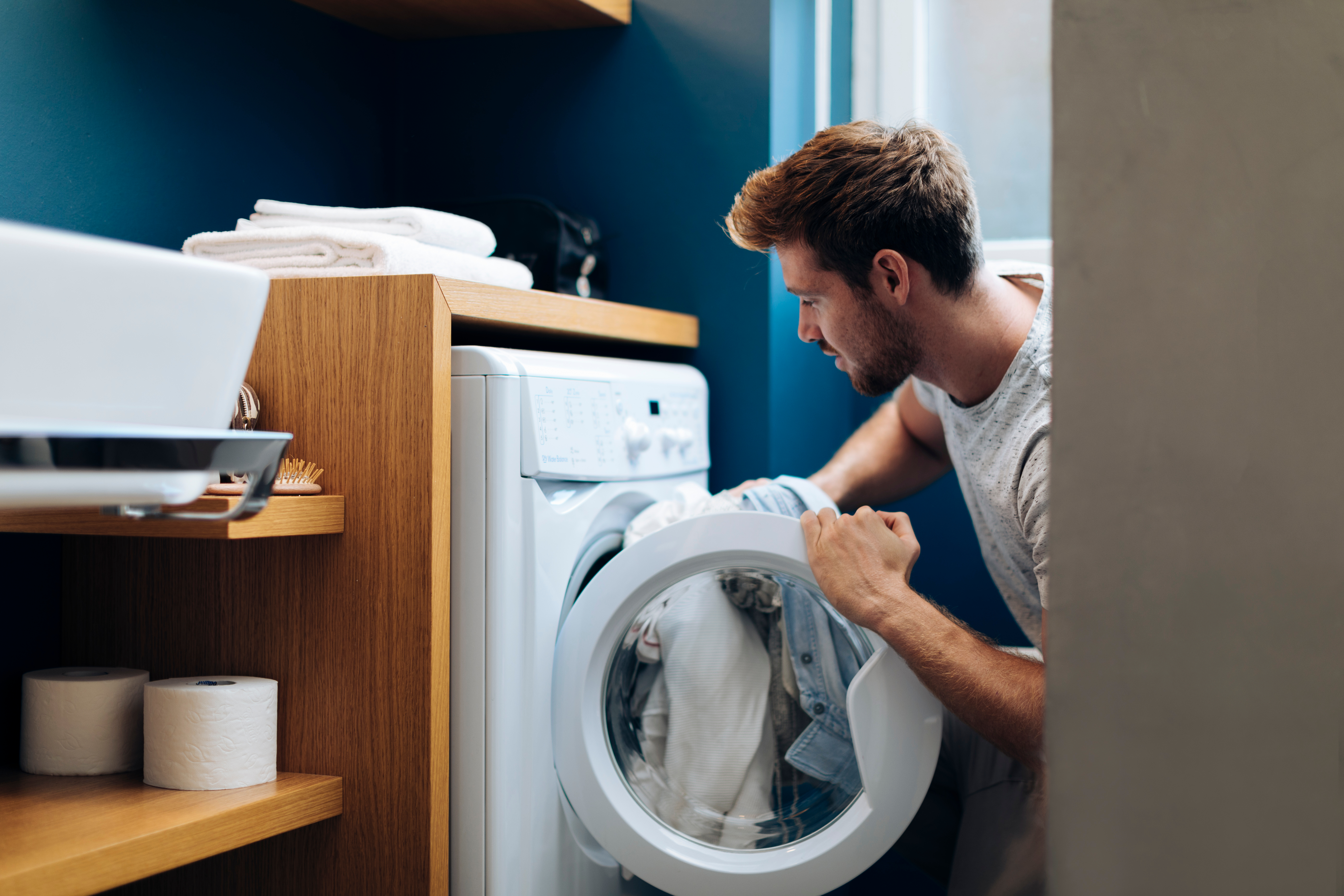 Dad taking laundry out of washing machine