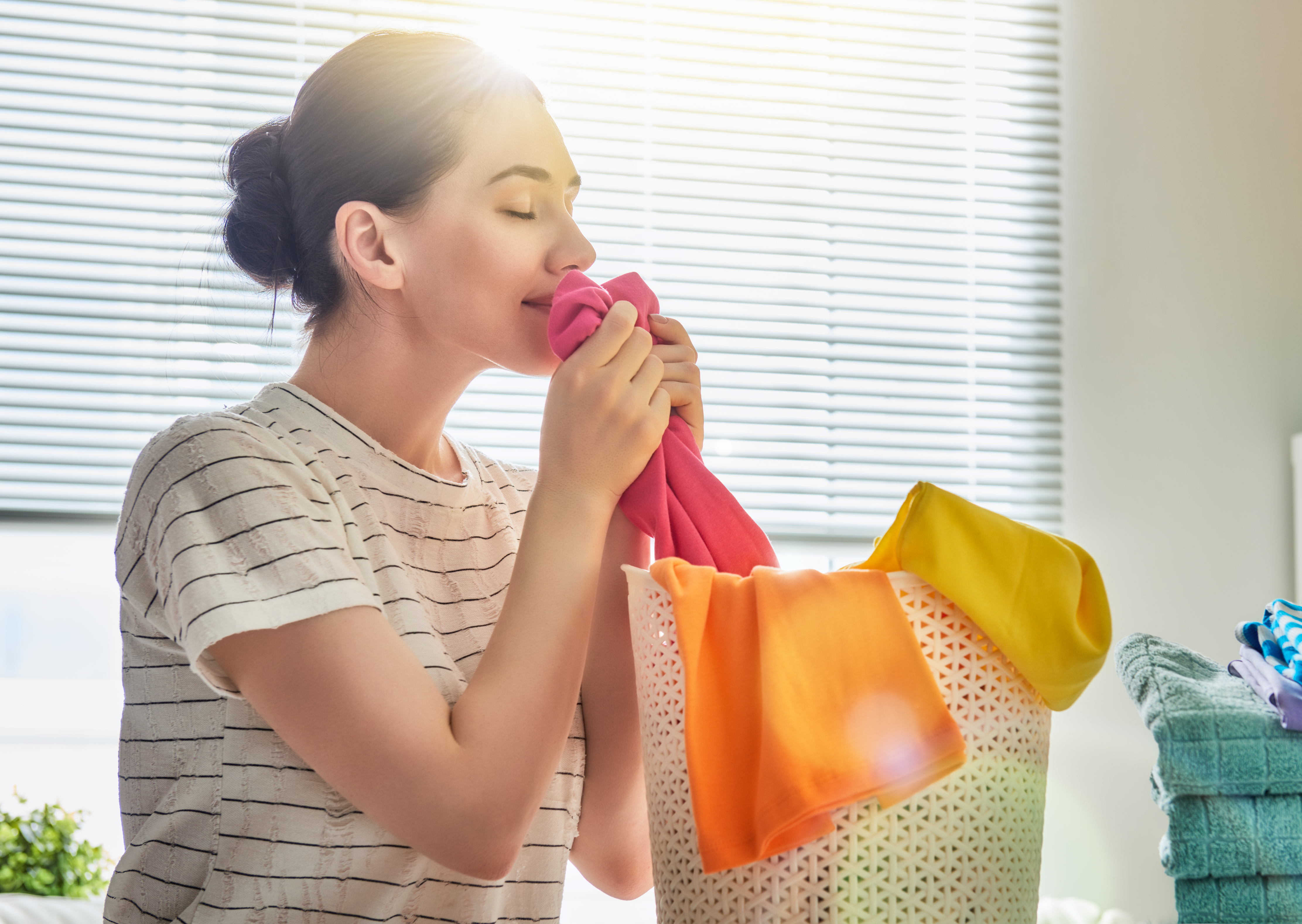 Woman smelling freshly cleaned clothes