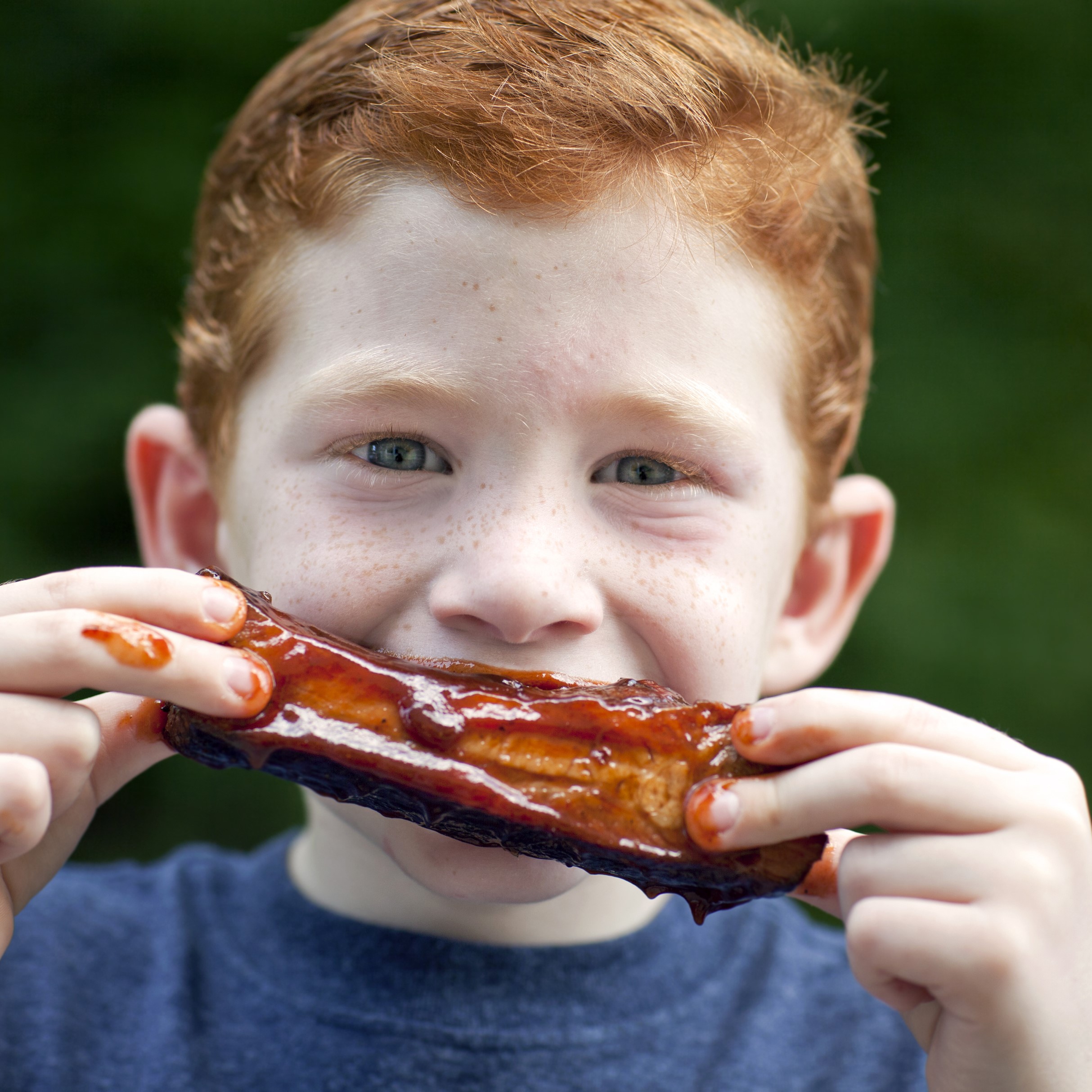 Young boy enjoying barbeque food