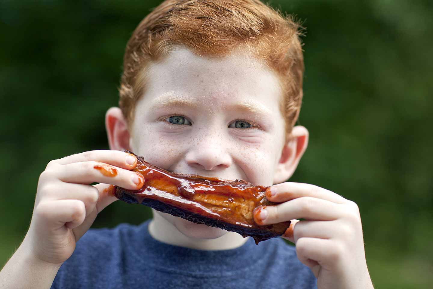 Young boy enjoying barbeque food